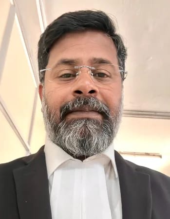 Advocate K. Neelamegam in High Court legal attire with advocate's bands